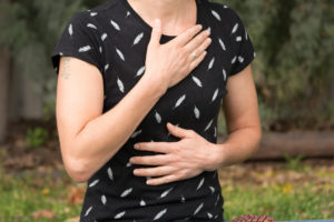 Photo of hands on self reiki - hands on chest and torso