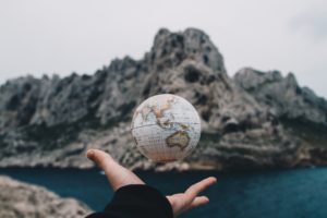 Levitating globe in hands representing remote Reiki healing