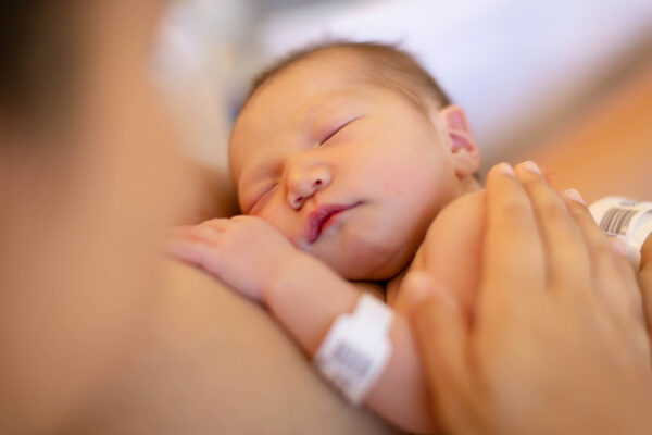 New born baby receiving Reiki from Mum in Hospital