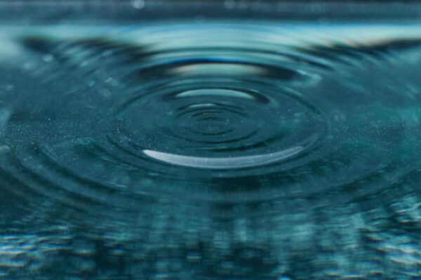 Ripples resonating outwards like teh energetic ripples of reiki mass Ripples in water expanding outward, representing morphic resonance and expanding healing energy
