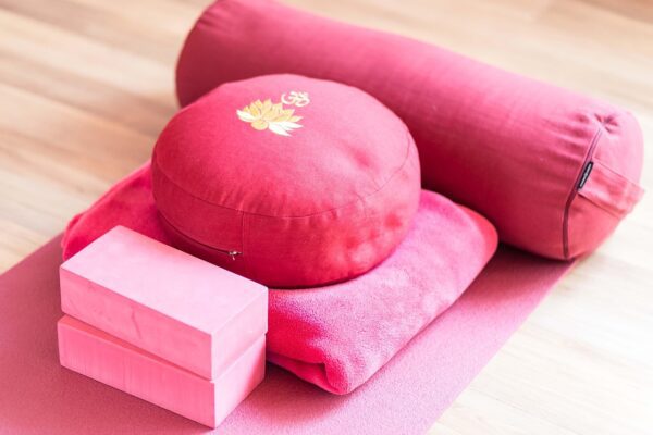 Pile of cushions, blankets and bolster on a mat, ready for Reiki Mass in Hilton, WA Pile of cushions, blankets and bolster on a mat, ready for Reiki Mass